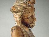 a wooden statue of a man with a crown of thorns on his head