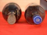 two bottles of wine sitting on a red table