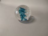 a glass bowl with a blue fish inside of it