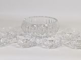 an image of a group of crystal bowls and cups on a white surface