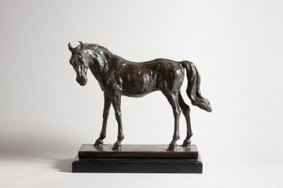 statue of a horse standing on a marble base against a white background