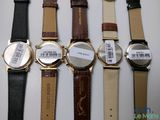 several different watches are lined up in a row on a table