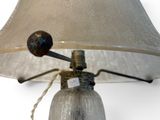 a lamp that is sitting on a table with a white shade