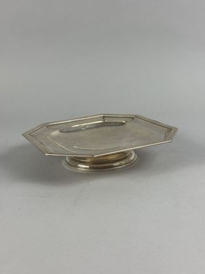 une petite assiette en argent ornée d'un motif de feuilles