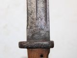 a close up of a knife on a wooden stand