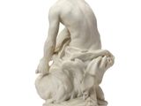 a white statue of a man sitting on top of a sheep