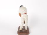 figurine of a baseball player on a base on a white background