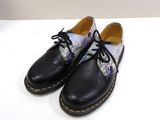 a pair of black shoes with a floral print on them