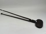 an old pair of tongs sitting on top of a white surface