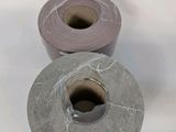 two rolls of toilet paper sitting next to each other on a white surface