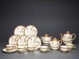 a group of porcelain tea and coffee cups and saucers