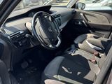 the interior of a car with the door open showing the driver ' s seat and dashboard