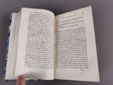 someone is holding a book open to a page with a picture on it