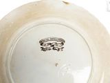 a white plate with a design on it on a table
