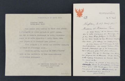 an old letter with a leaf on it sitting next to a piece of paper