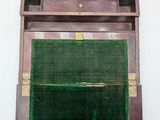 a wooden box with a green cloth inside of it