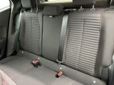 two seats in the back of a car with red trims