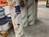 Plusieurs rouleaux de papier sont empilés les uns sur les autres dans un entrepôt