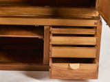 a wooden cabinet with drawers and a door open