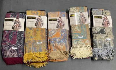 six pairs of scarves are lined up in a row on a table
