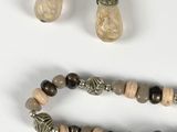 two pieces of jewelry including a necklace, bracelet and earrings