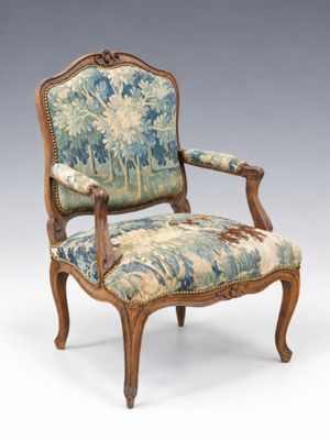 an image of a chair with a floral upholstered back and arms
