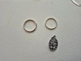 two rings and a coin on a white surface