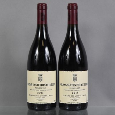 two bottles of wine sit on a table with a gray background
