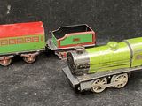 three toy trains sitting next to each other on a table