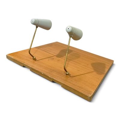 two lamps that are on top of a wooden board