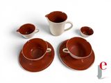 four cups and saucers sitting on a white table
