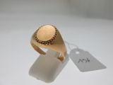 an image of a gold signet ring on a white surface with a price tag