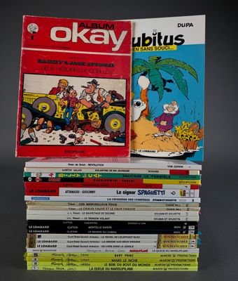 several comics are stacked on top of each other on a table