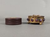 pair of gold and amethoral jewelry boxes with purple stones