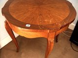 a wooden table with a wooden top on a carpeted floor