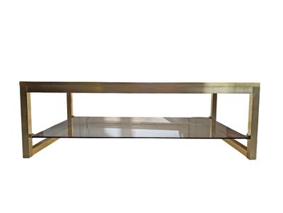 a brass coffee table with a glass shelf on top of it