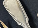a spoon, fork, and spoon rest on a table