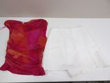 a white skirt and a pink top on a table
