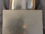 a silver object sitting on top of a table