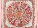 a red and white scarf with a circular design on it