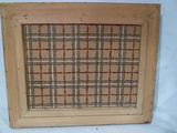 an old window frame with a plaid pattern on it