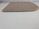 a close up of a beige cushion on a white table