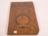 an old wooden book with a picture of a woman on it
