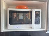 someone is taking a picture of themselves in a microwave in the kitchen