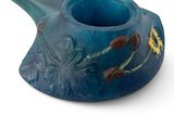 a blue vase that has a flower design on it