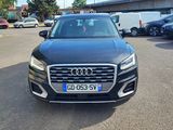a black audi suv parked in a parking lot next to other cars