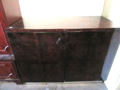 a brown cabinet with a mirror on top of it