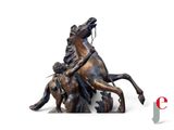 a statue of a man riding a horse with a woman on it