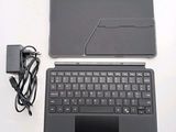 a laptop with a keyboard and a charger on the table