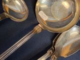 a lot of silver spoons and spoons on a table
